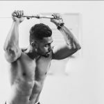 grayscale photo of man in gym